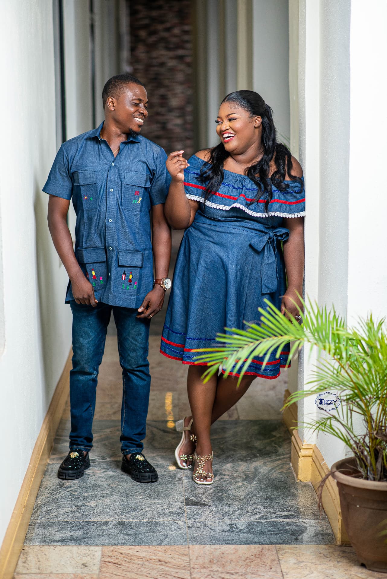 Fabiola and Akinwande Robert laughing together in matching Haitian denim outfits